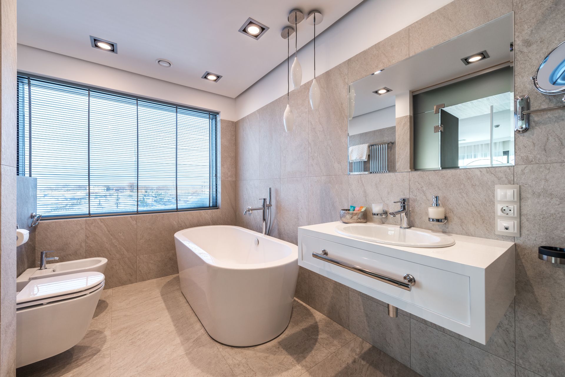 Modern bathroom with a freestanding bathtub and polished vanity