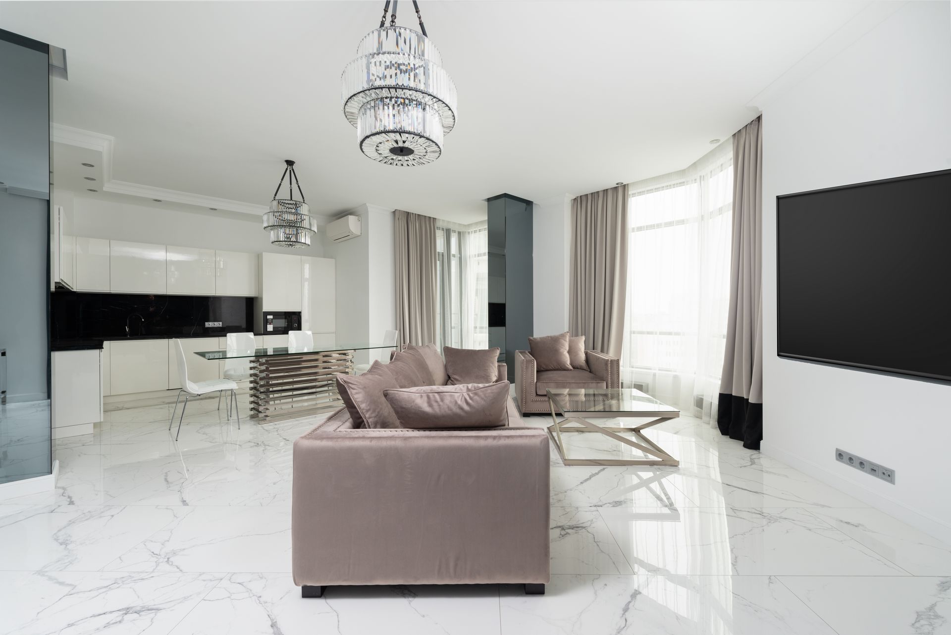 Spotless luxury living room with marble floors, velvet seating and a dining area